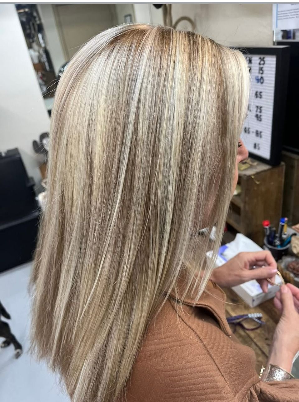 Long blonde hair with multi-tonal highlights and lowlights, blown out straight — colour by Hair Barn, Tyler TX